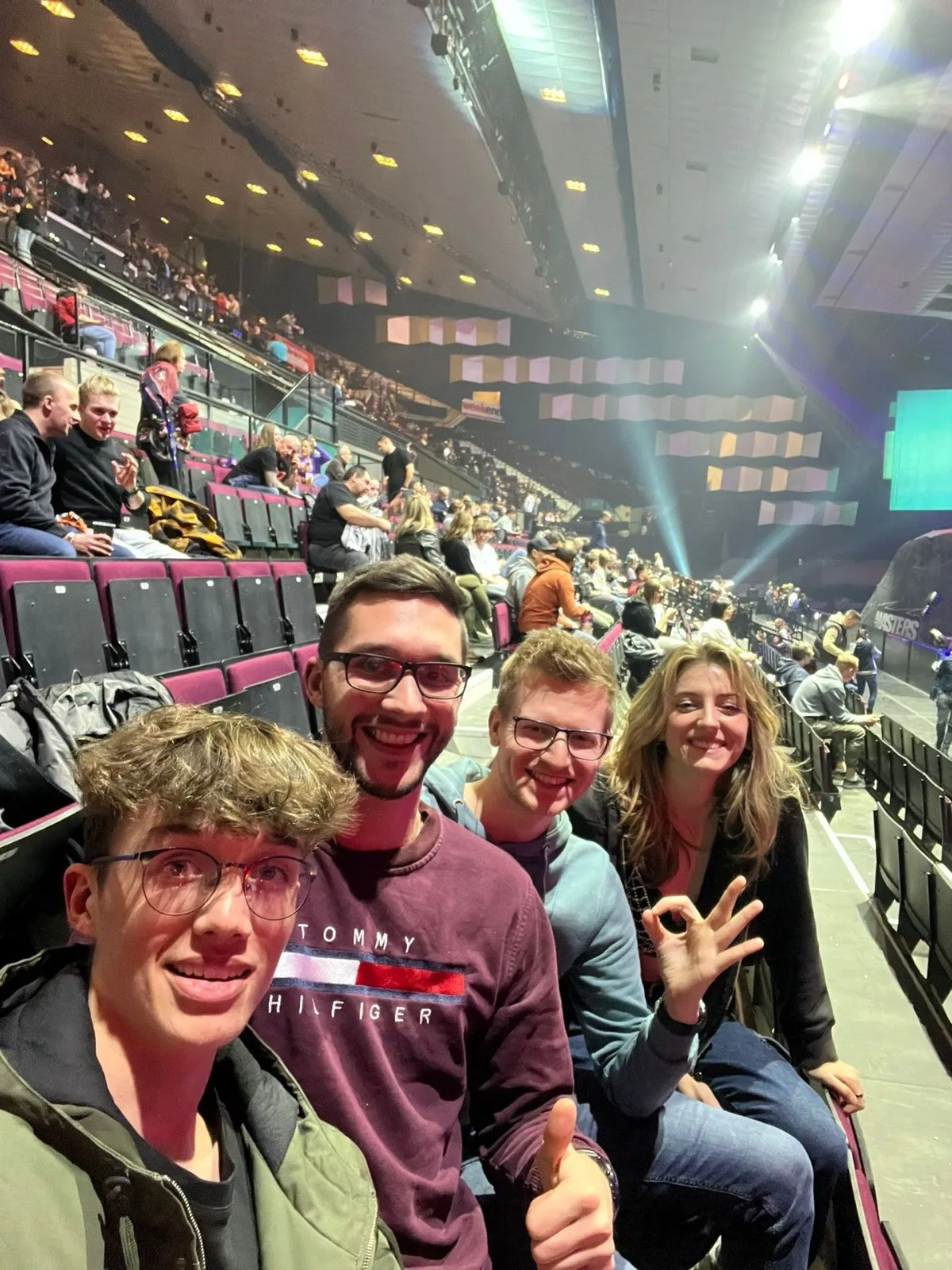 A group selfie in the stands at an event